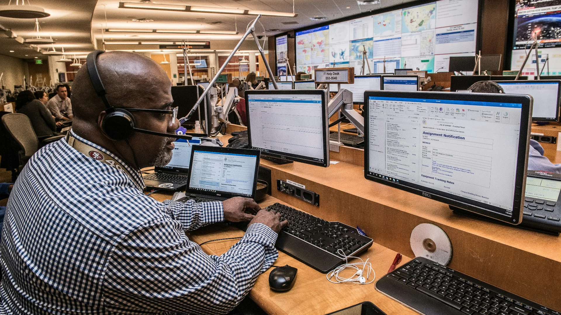 Operations center with monitoring screens and support desks